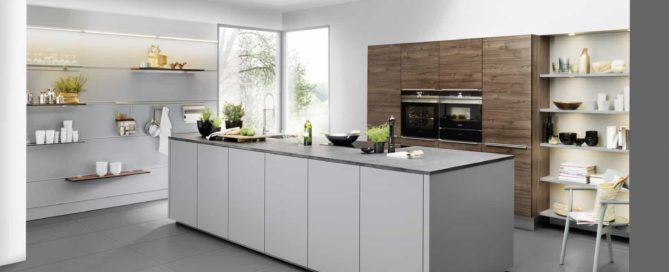 Küchenstudio Eine moderne Küche mit weißen Schränken und grauen Arbeitsplatten.