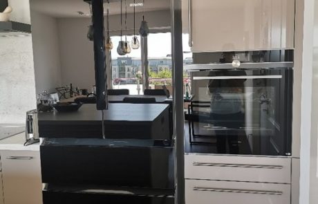 Küchenstudio Eine Küche mit einem stilvollen schwarz-weißen Kühlschrank.