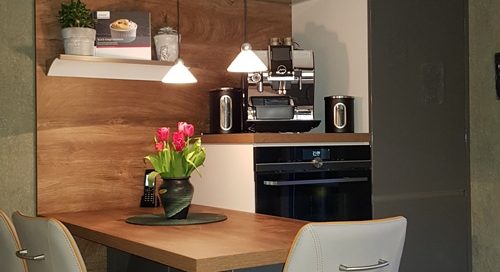Küchenstudio Eine kleine Küche mit Esstisch und Stühlen präsentiert Referenzen.