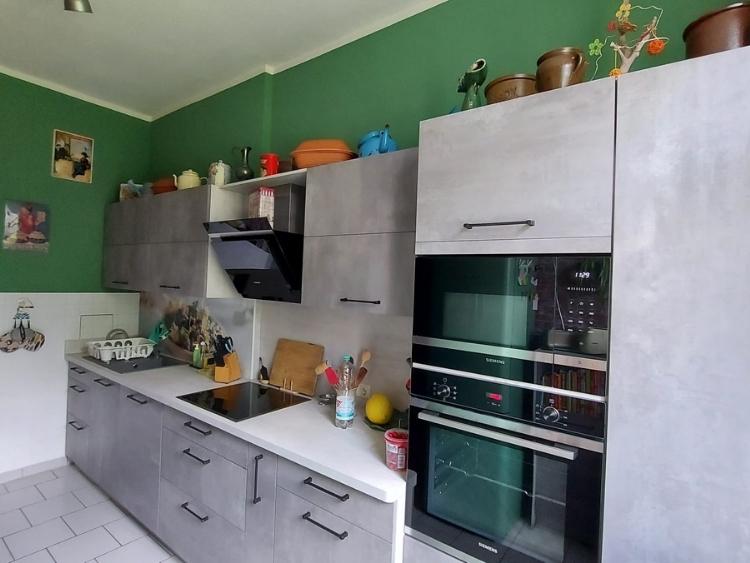 Küchenstudio Eine Küche mit grünen Wänden und einem grünen Ofen.